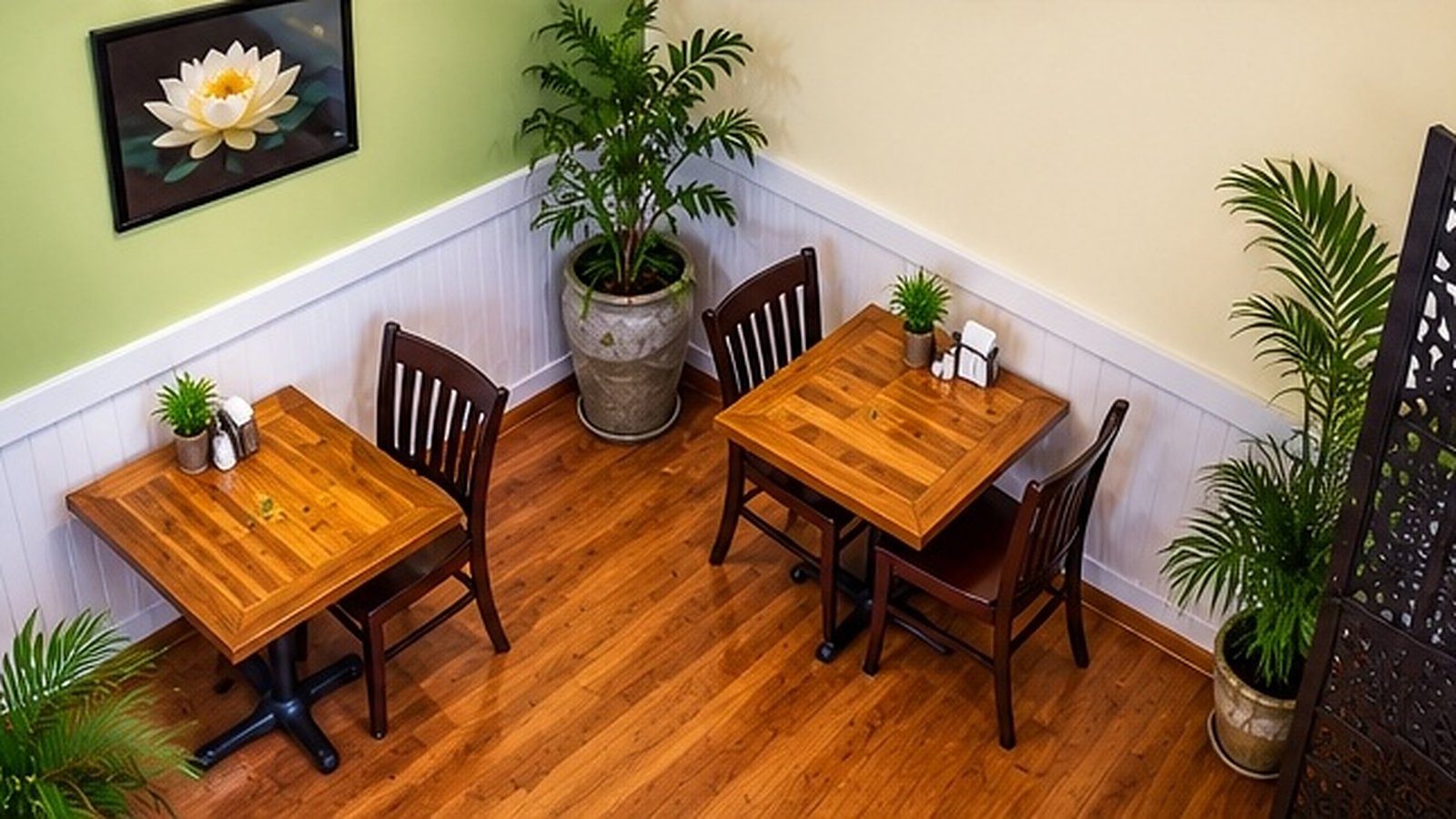 Cozy corner of Crepas Café with wood tables and green walls