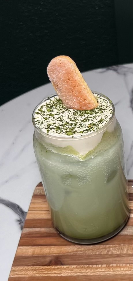 Iced matcha tiramisu drink with foam and ladyfinger